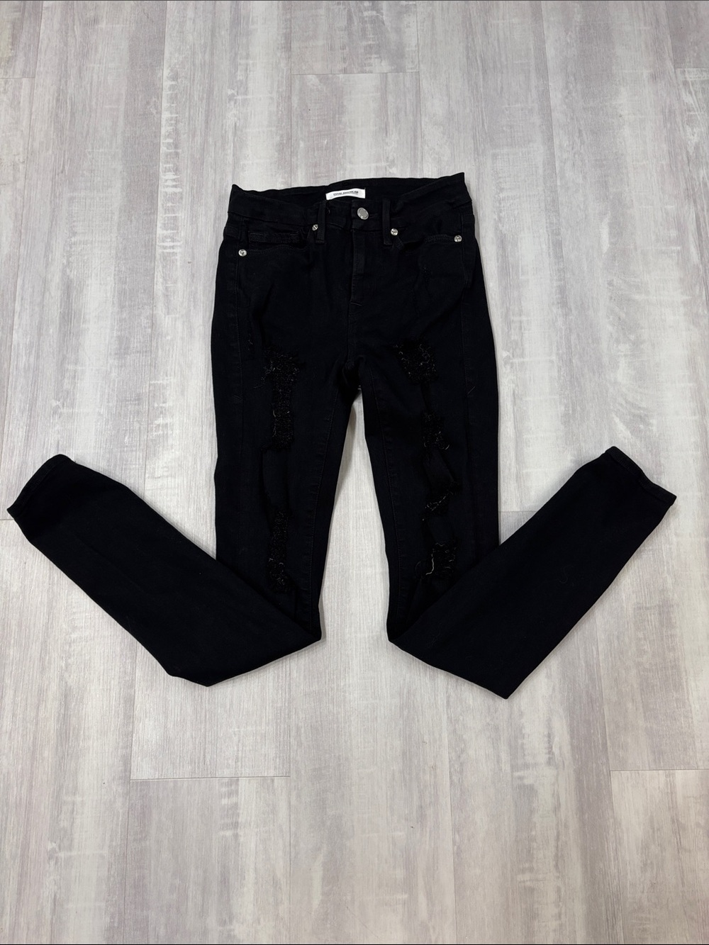 Good American Black Skinny Jeans with Subtle Distressed Detailing